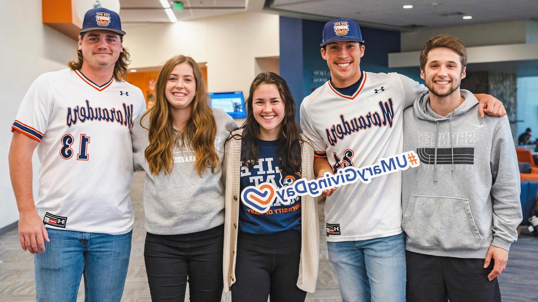 Students holding a Giving Day sign